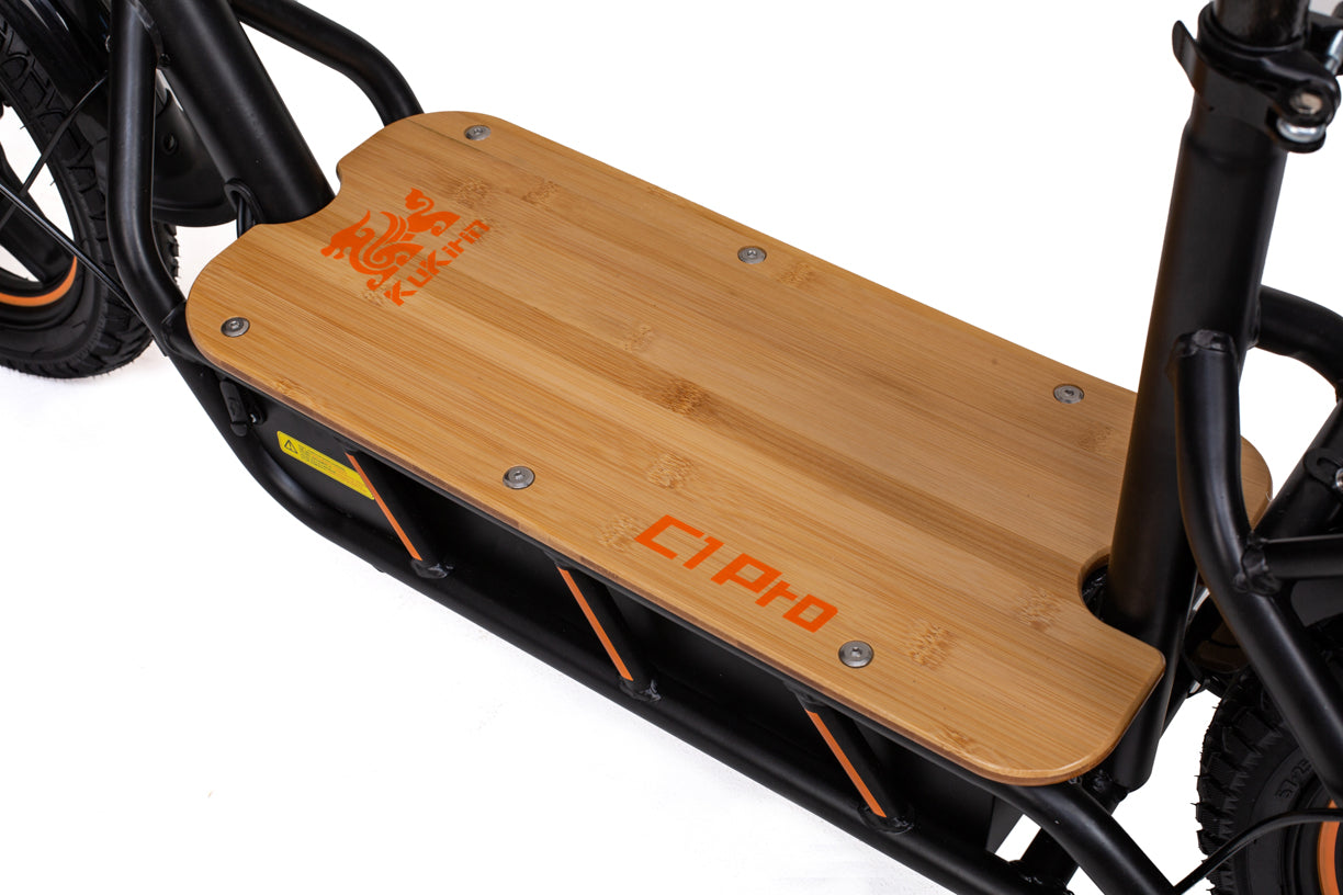 Close-up of a wooden platform on an kukirin c1 pro electric scooter with visible branding.