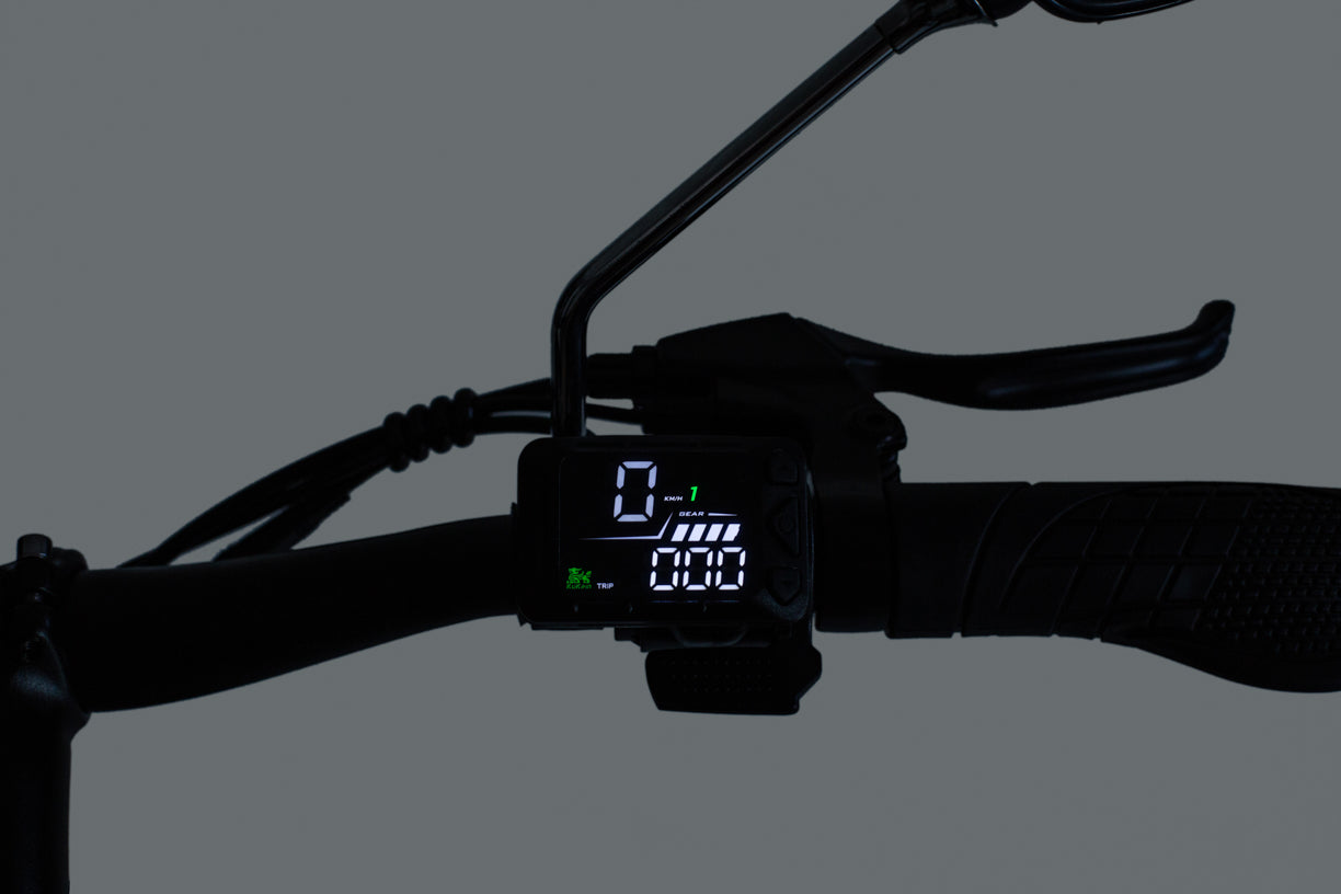Digital display on a kukirin c1 pro electric scooter handlebar against a dark background