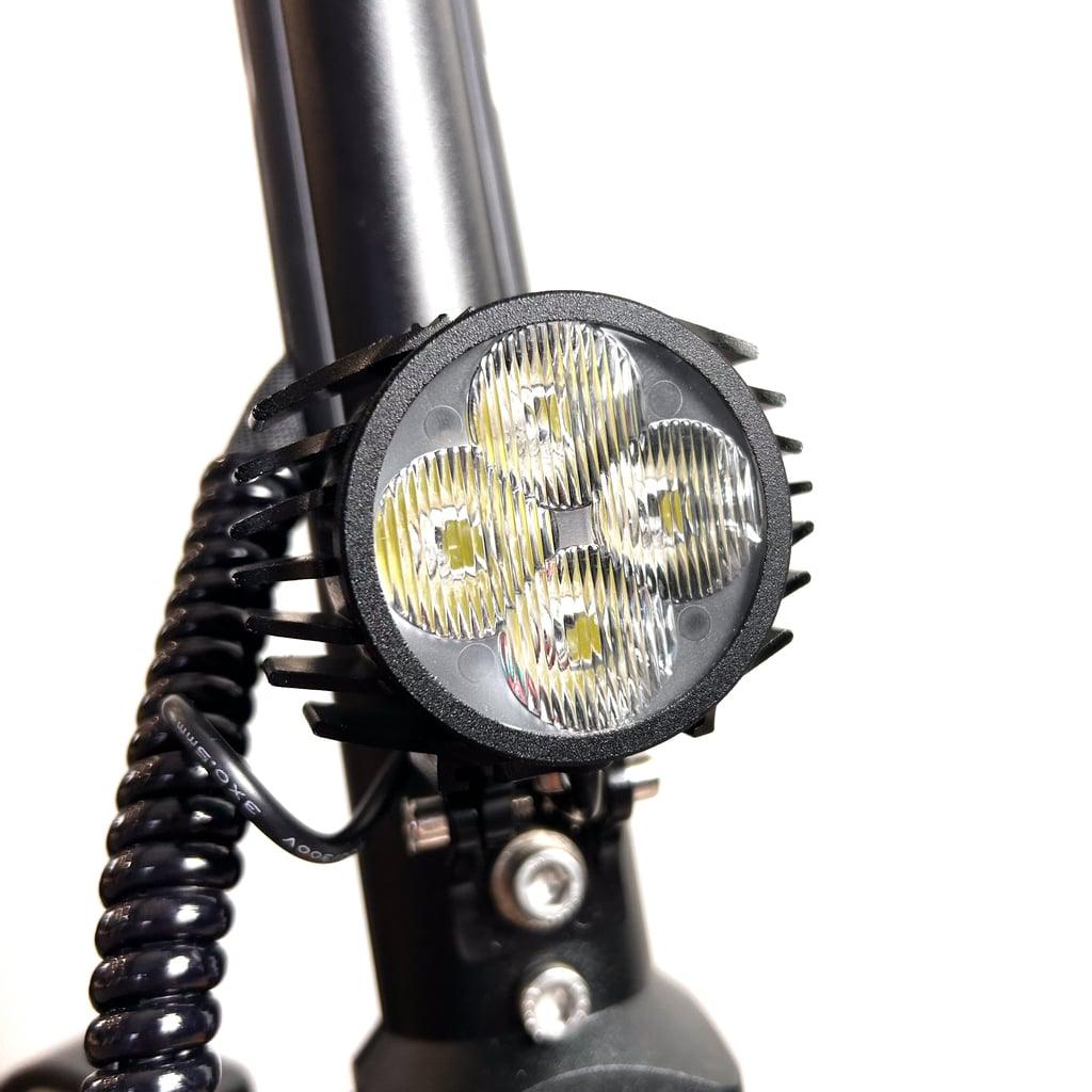 dualtron mini headlight attached to a bike frame with a white background
